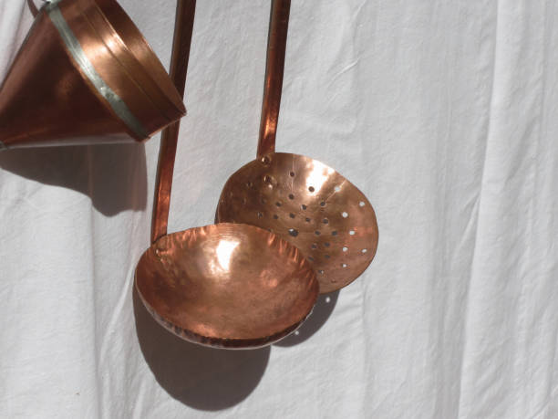 istock Traditionally handcrafted copper kitchen utensils against white background . Tuscany, Italy 1193141725