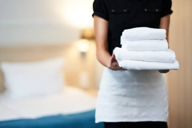 istock Maid with fresh towels in hotel room 1193142047