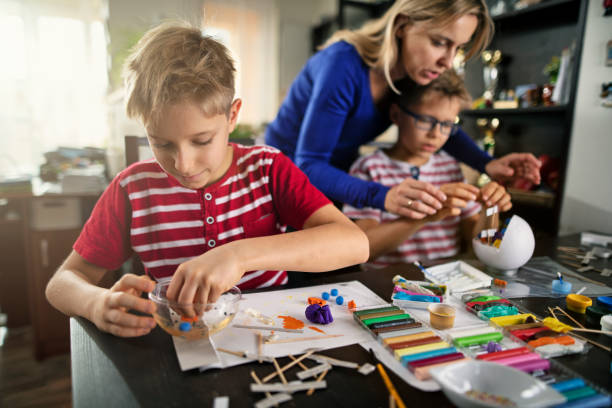 Mother and sons making cell models of for school Little boys  preparing science school projects. The boys aged 10 are building biological cell model cytoplasm photos stock pictures, royalty-free photos & images