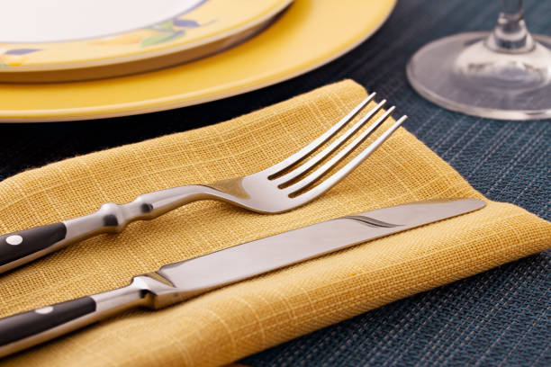 istock serving knife, fork and plate in yellow - blue tones, shot on a texture tablecloth 1193142165