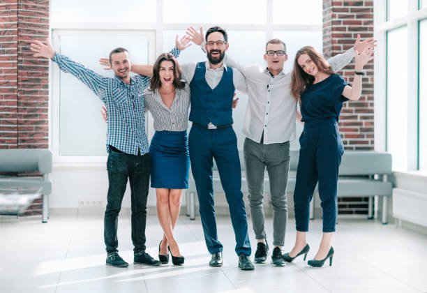 istock happy business team standing in a bright office 1193143049