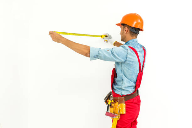 istock Worker in hard hat measure with ruler. Isolated on a white background. 1193143055