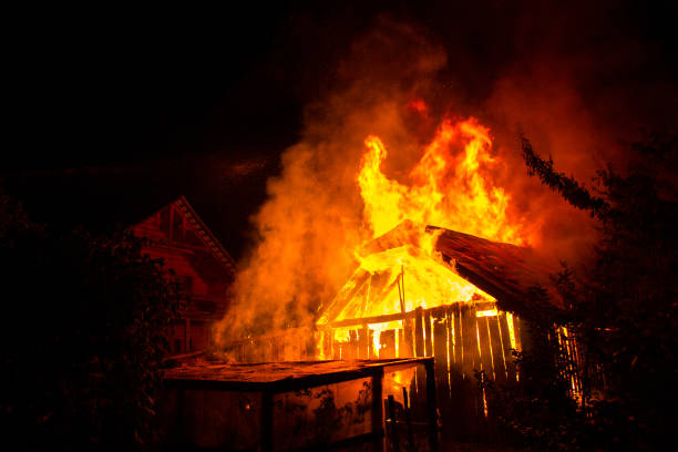 istock Wooden house or barn burning on fire at night. 1193143482