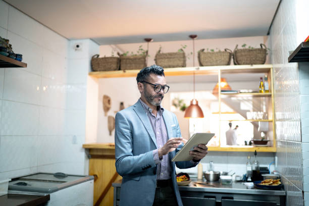 istock Businessman/owner using digital tablet in a restaurant 1193143512