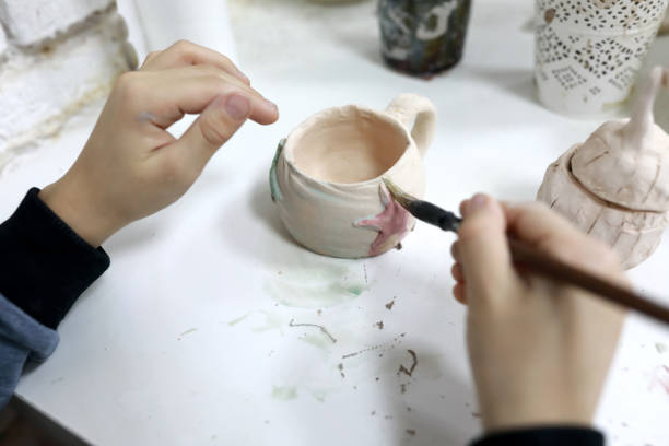 istock Person painting clay mug 1193145022