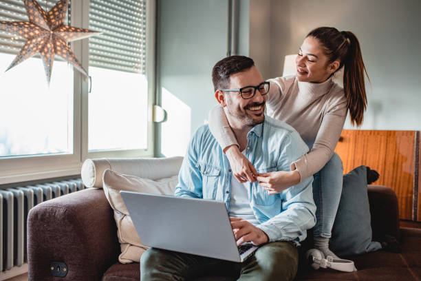 istock Young couple in home using laptop 1193145058