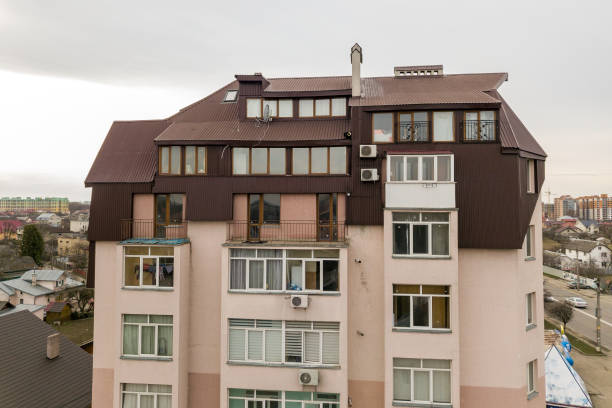 istock High apartment building with many windows and metal sheets roof. 1193145421