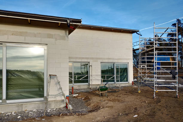 istock Facade of building made from white blocks with big windows under construction works. 1193145427