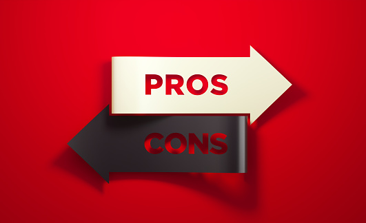 Black and white arrows pointing opposite directions on red background. Pros and cons antonym reads on the arrows. Dilemma and choice concept. Horizontal composition with copy space.