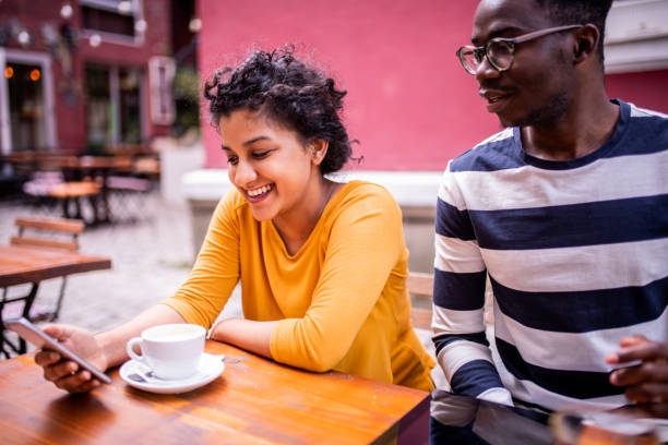 istock Two friends sitting at a coffee shop 1193146466