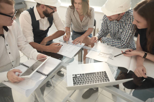 istock architect and designers discussing sketches for a new project 1193147370