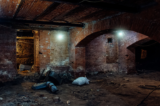 Abandoned empty old dark underground vaulted cellar.