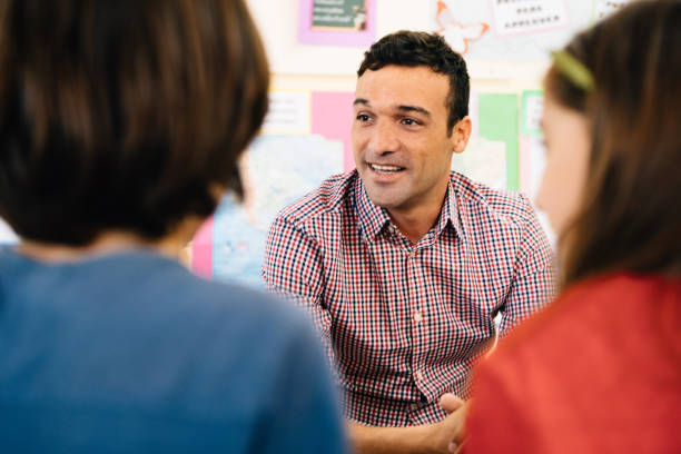 Student Counselling Teacher Counselling students in Classroom primary school assembly stock pictures, royalty-free photos & images