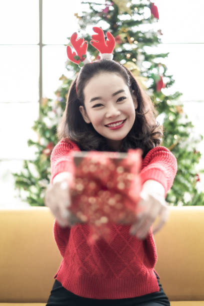 istock Woman Holding Present Gift Box 1193151070