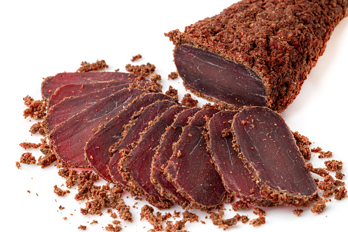 Jerky on a white background. Close-up of basturma sliced into pieces.