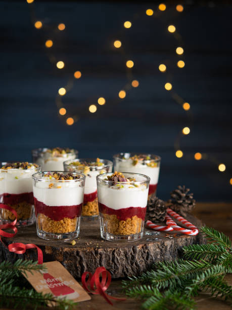 Dessert in a glasses with chocolate and berries spread on wooden background, garland lights bokeh and christmas decoration. Christmas, new year holidays background concept. Dessert recipe ideas. Dessert in a glasses with chocolate and berries spread on wooden background with garland lights bokeh and christmas decoration. Christmas, new year holidays background concept. Dessert recipe ideas. trifle stock pictures, royalty-free photos & images