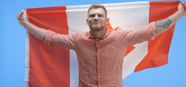 istock Young man dancing and holding Canadian flag 1193152855