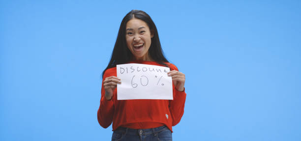 istock Young woman holding discount sign 1193153399