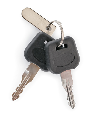 Set of car, motorcycle or furniture keys with metallic label. Isolated on white, clipping path included