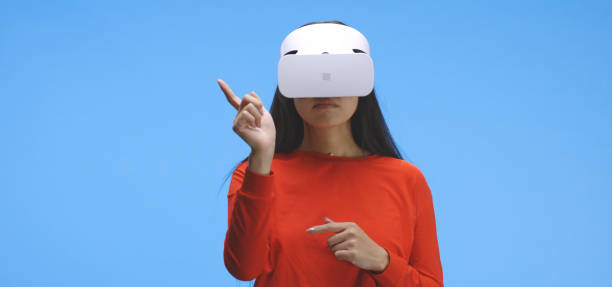 istock Young woman wearing vr headset and doing hand gestures 1193154065