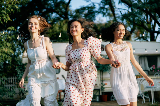 istock Happy multi ethnic women running and having fun together outdoors during a picnic. 1193154116