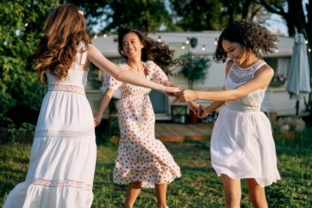 istock Happy beautiful women dancing in circle during a picnic 1193154127