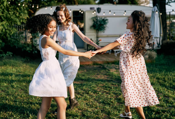 istock Happy beautiful women dancing in circle during a picnic 1193154142