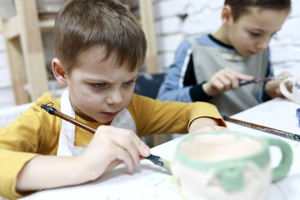 istock Children paint clay mugs 1193154346