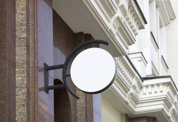 istock Blank white outdoor round box mockup hanging on marble wall 1193154893