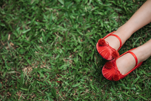 Close up of a woman bare feet walking on the grass