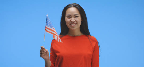 istock Young woman waving with us flag 1193155531