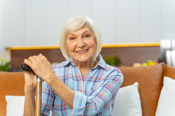 istock Modern aged lady with a cane smiling happily 1193156220