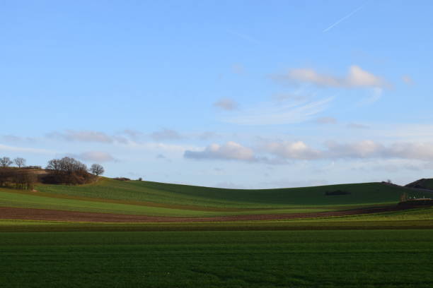 istock green winter hills und light blue sky 1193156571