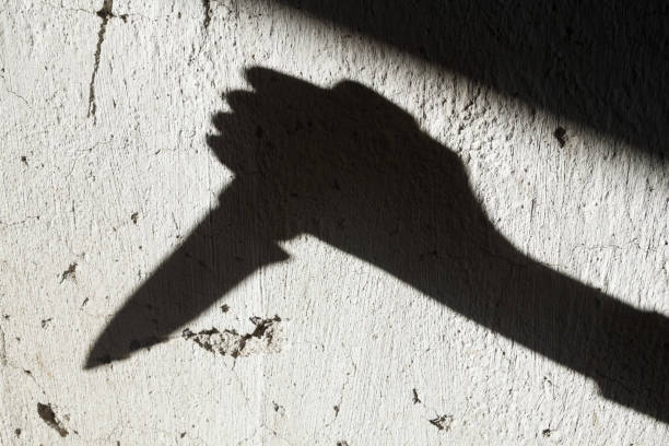 istock Shadow of the hand holding a knife 1193156893