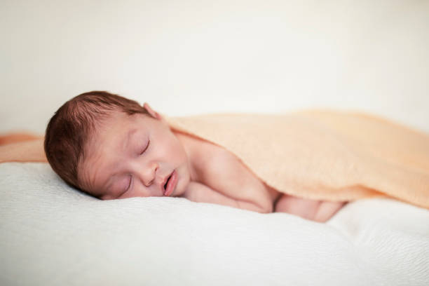 istock Newborn baby sleeps under a blanket 1193158224