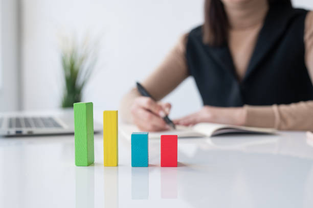 istock Multi-color cube chart on desk on background of accountant or broker 1193161557
