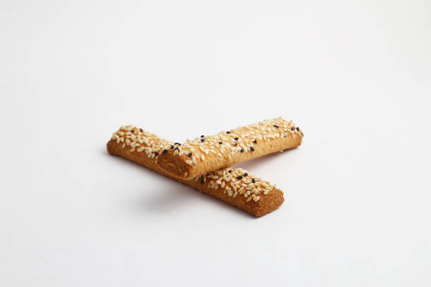 Bread sticks with mix of seeds on white background