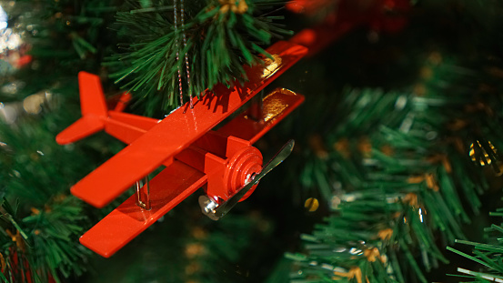 Christmas decorations on the Christmas tree. The red plane.