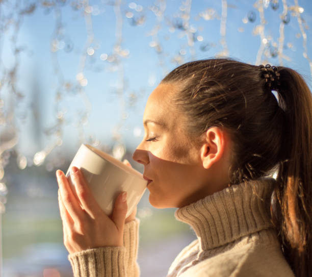 istock Girl drinking coffee in christmas ambient 1193168801