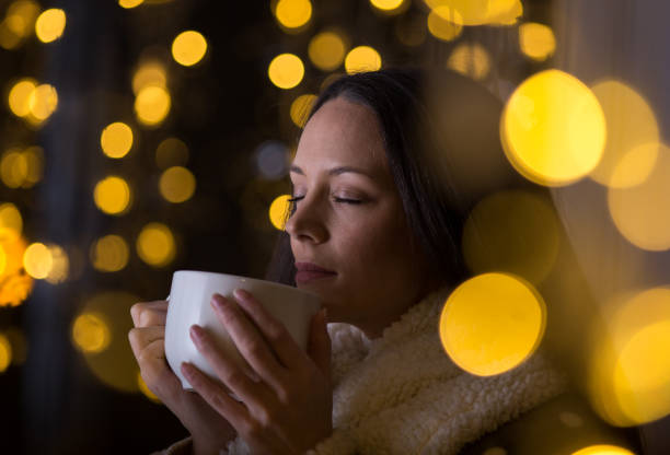 istock Girl drinking coffee in christmas ambient 1193168837