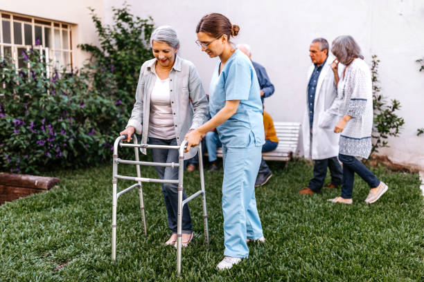 istock Nurse assisting senior woman with mobility walker 1193172708
