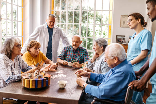 istock Nursing staff with seniors playing cards 1193172847