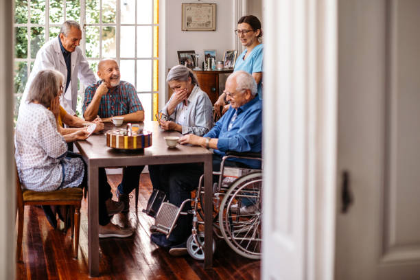 istock Nursing staff with seniors playing cards 1193173486