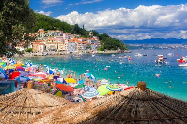 Sunny beach of Moscenisca Draga, in Croatia MOSCENISCA DRAGA, CROATIA - AUGUST 3. 2019 - Summer beach in Moscenisca Draga, in Croatia croatian culture photos stock pictures, royalty-free photos & images