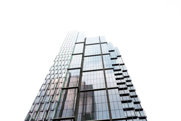 istock Low angle view of modern glass office building, skyscrapers, white background with copy space 1193176806