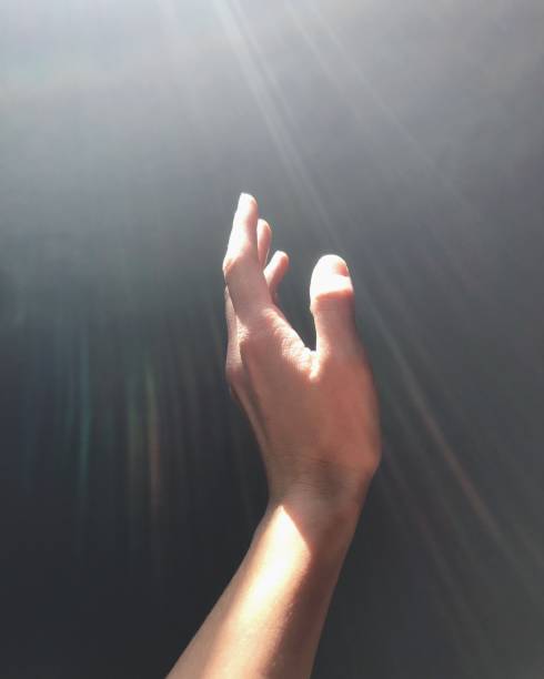 istock hand reaches for the light 1193185494