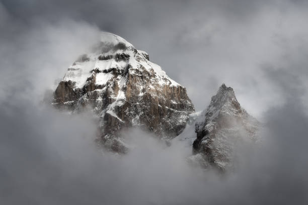 istock Clouds envelop a snowcapped mountain in the Andes Mountain Range of Peru 1193189728
