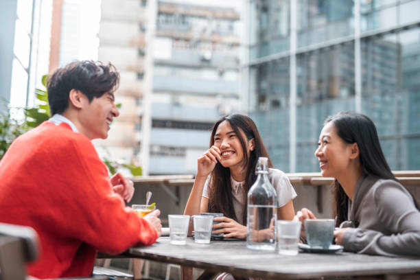 istock Three Chinese friends talking and having fun at a cafe 1193198686