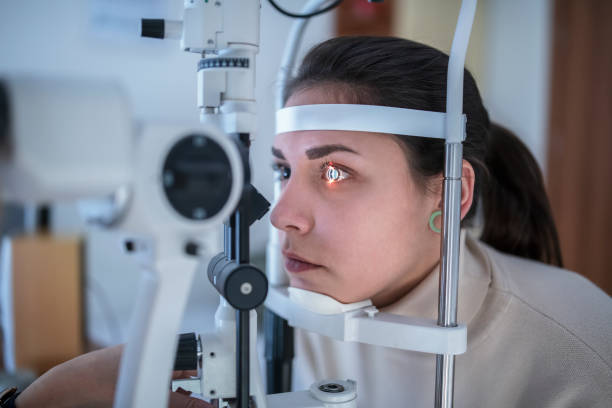 istock Female patient having eye tested in hospital 1193198780