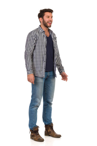 istock Handsme Man In Jeans And Unbuttoned Lumberjack Shirt Is Standing And Talking. Side View. 1193199575
